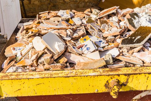 View of construciton site of house improvement and garbage skip container with building rubble