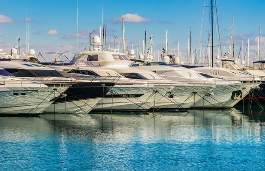 Luxury yachts anchored in a row at mediterranean harbor