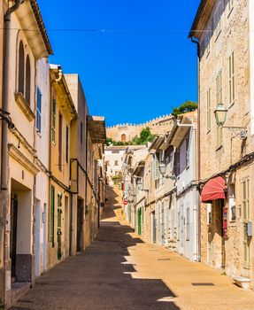 Street view in the historic town of Capdepera with fortified wall in the background, Spain Mallorca island