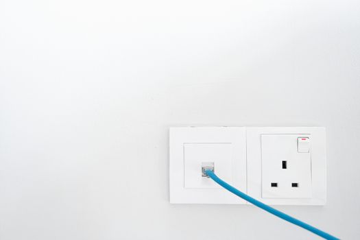 Power socket and Internet socket. Socket Malaysian type. Socket with switch on a white wall