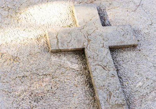 Top view of cemetery tombstone with stone cross and copy space