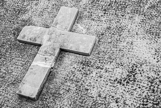 Paying his respects, tombstone with stone cross and copy space