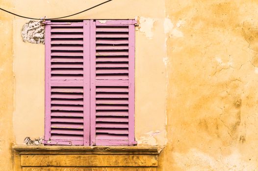 Detail view of wooden window shutters and wall background

