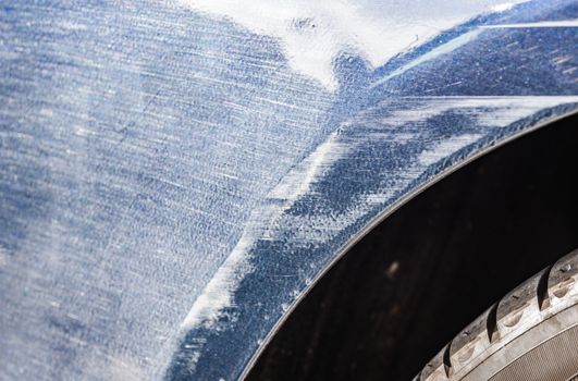 Car accident with detail view of damaged scratched fender