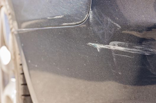 Car accident with close-up of damaged bumper 