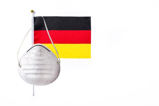 German flag and protective face mask isolated on white background.