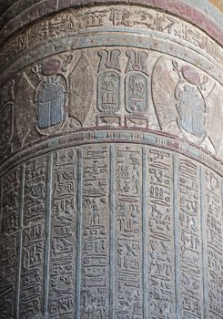 Hieroglypic carvings on a large stone column at the ancient egyptian temple of Khnum in Esna