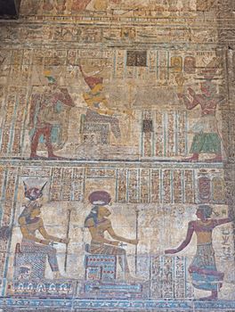 Hieroglypic painting carvings on wall at the ancient egyptian temple of Khnum in Esna Luxor showing gods sekhmet and hathor