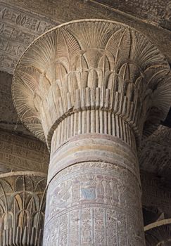 Columns in the ancient egyptian temple of Khnum at Esna with painted hieroglyphic carvings