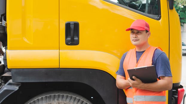 Professional worker truck driver, confident middle-aged Asian man wearing safety clothing Smile proudly In moving forward For a long transportation business