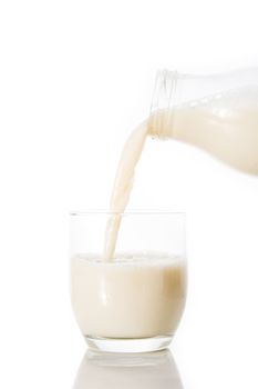 Oats milk in a bottle on wooden table