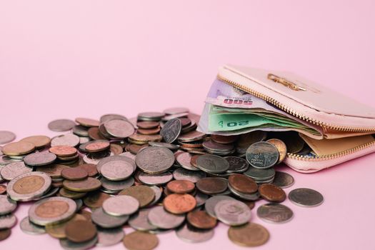 Wallet with Thai currency banknote and money coins on pink background for business, finance, investment and saving money concept