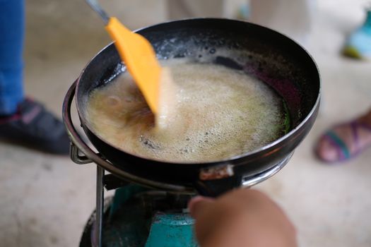 heating cooking boiling sugar caramel syrup in pan