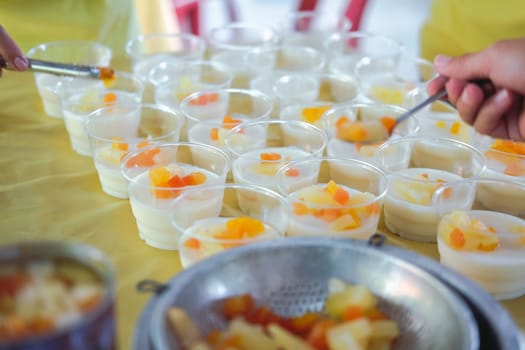 soy milk pudding with fruit in plastic cup. vegan dessert for vegetarian
