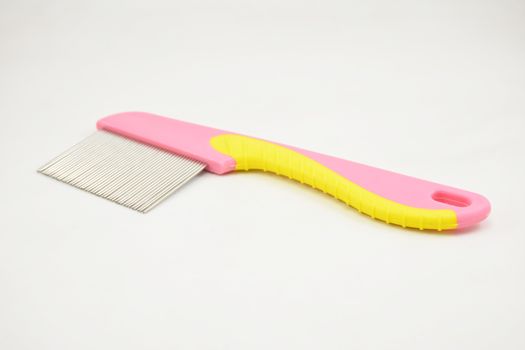 Lice comb stainless steel tooth pink and yellow handle use to remove nits and lice on hair
