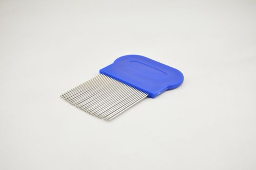 Lice comb stainless steel tooth blue handle use to remove nits and lice on hair