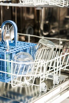 Open dishwasher with dirty crockery