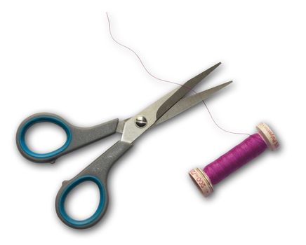 A pair of sowing scissors cutting pink sowing yarn