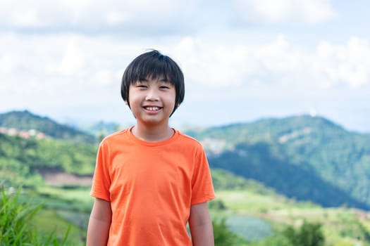 Portrait little boy with scenery mountain.  Adventure concept