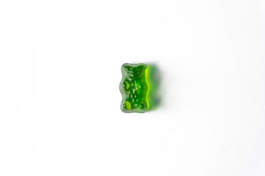 Pile of multicolored jelly bears candy on a white background.