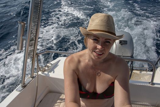 Croatia, Hvar - June 2018: Caucasian woman, sat in a small boat on vacation