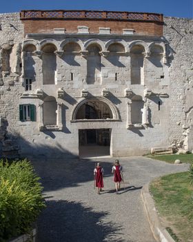 Croatia, Split - June 2018: Re-enactors dressed as Roman Legionnaires, wait to pose with Tourists at the gates to the  Diocletian Palace