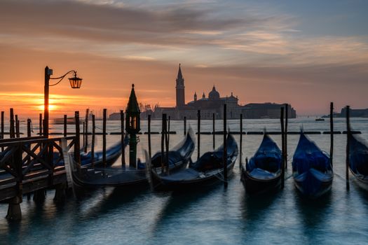 Venice sunrise with gondolas in the foreground