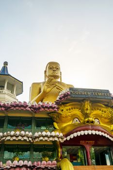 Dambulla, Sri Lanka, Aug 2015: Giant Golden Buddha statue overlooking the modem temple at Dambulla