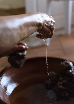 Essaouria, Morocco - September 2017: Making Argan Oil by Hand - squeezing pulp to release oil
