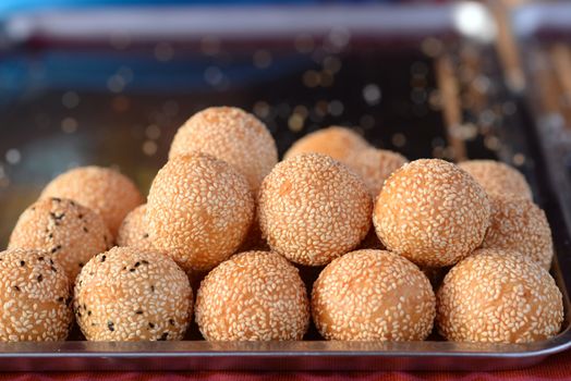 Sesame Seed Balls  is a famous Thai desserts. A golden brown shell of sesame studded rice flour that is crispy on the outside yet chewy on the inside, yielding to a sweet and moist mung bean coconut filling.