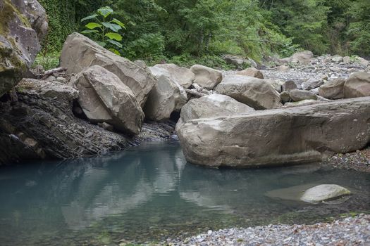 Mountain river blocked by stones in the Caucasus