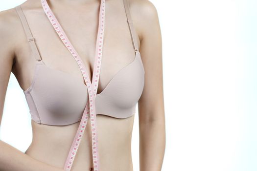 Woman measuring her chest for breast implant surgery.