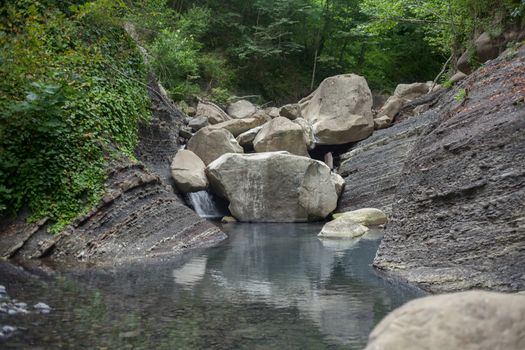 Mountain river blocked by stones in the Caucasus