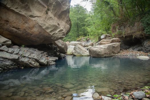 Mountain river in the stone bed at summer