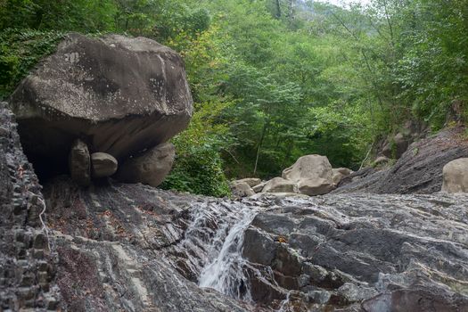 Mountain river in the stone bed at summer