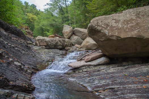 Mountain river in the stone bed at summer