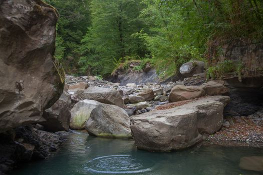 Mountain river in the stone bed at summer