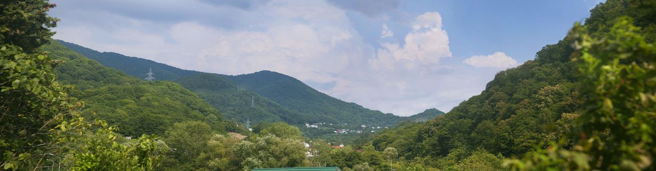 Village in the forested mountains in the summer