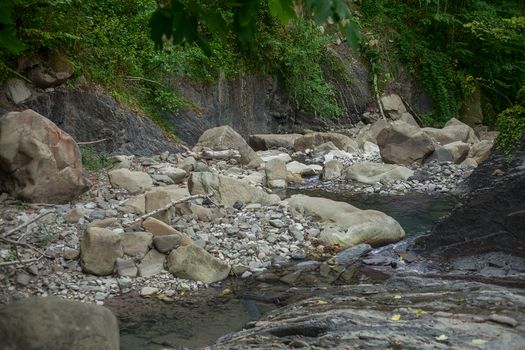 Mountain river in the stone bed at summer