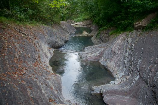 Mountain river in the stone bed at summer