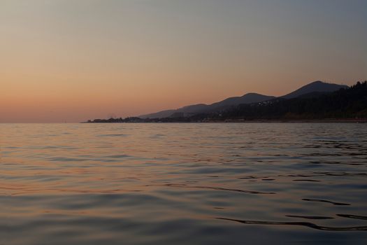 View on the mountains of Caucasus from the Black Sea at sunset