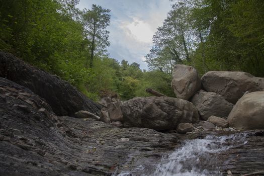 Mountain river in the stone bed at summer