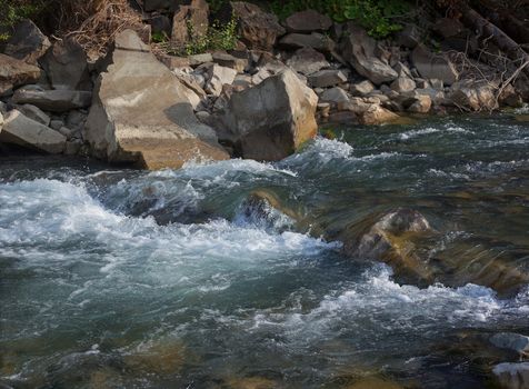 Rapid mountain river in a stone channel