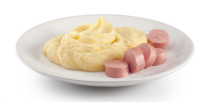 Mashed potatoes with boiled small sausages on the plate