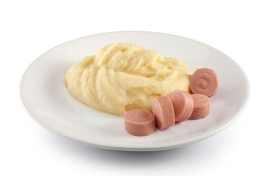 Mashed potatoes with boiled small sausages on the plate