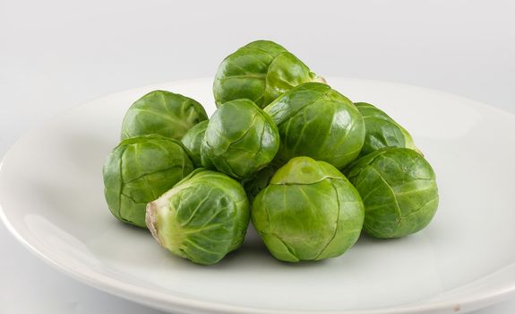 Handful of fresh green brussels sprouts on the plate
