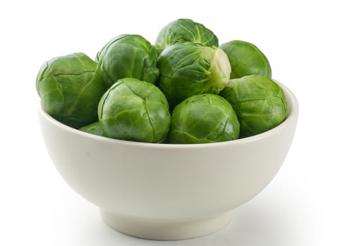Handful of fresh green brussels sprouts in the bowl