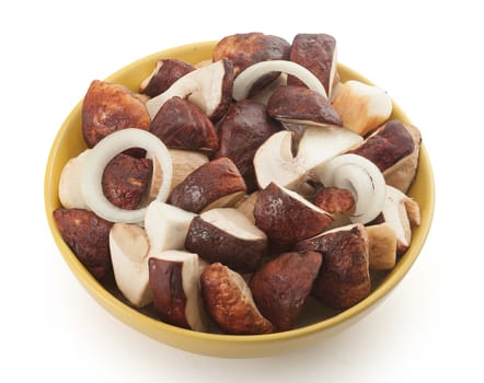 Pieces of white mushrooms and onion rings in the yellow bowl