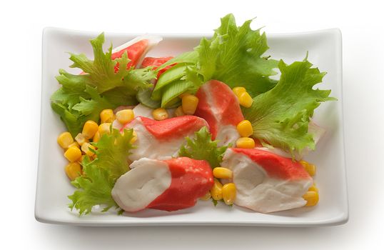 Crab meat with fresh green lettuce and corn's seeds on the plate