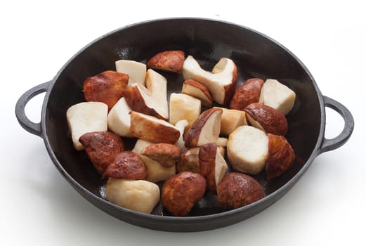 Pieces of white mushrooms in the black iron pan